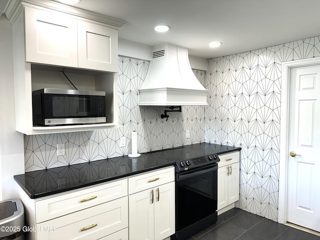 111 Rose St, Delanson, NY 12053 - kitchen with stainless steel microwave, custom exhaust hood, dark countertops, black / electric stove, and white cabinetry