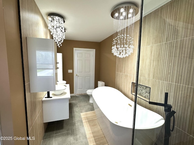 111 Rose St, Delanson, NY 12053 - bathroom featuring a soaking tub, toilet, vanity, and a chandelier