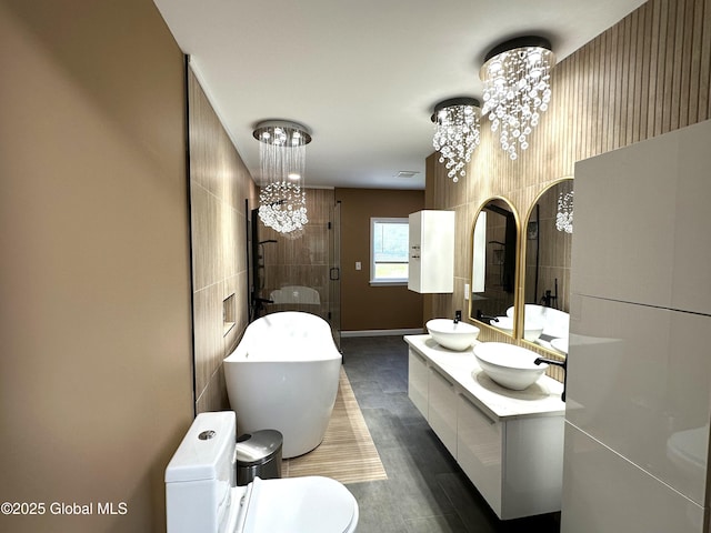 111 Rose St, Delanson, NY 12053 - full bathroom featuring a chandelier, a shower stall, a soaking tub, wood finished floors, and double vanity