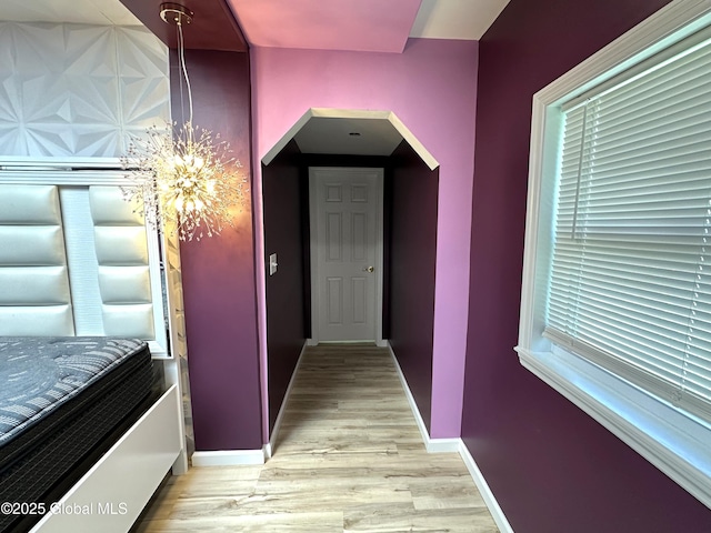 111 Rose St, Delanson, NY 12053 - corridor featuring arched walkways, a chandelier, light wood finished floors, and baseboards