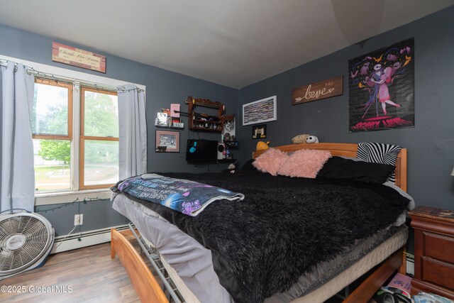 177 County Highway 155, Mayfield, NY 12025 - bedroom featuring wood finished floors and a baseboard heating unit