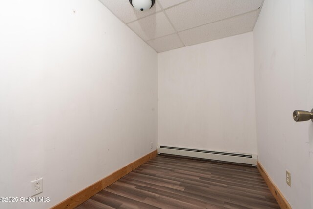 177 County Highway 155, Mayfield, NY 12025 - spare room featuring baseboard heating, a paneled ceiling, baseboards, and wood finished floors