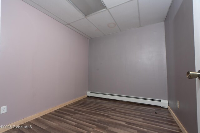 177 County Highway 155, Mayfield, NY 12025 - empty room with baseboard heating, dark wood-style floors, a drop ceiling, and baseboards