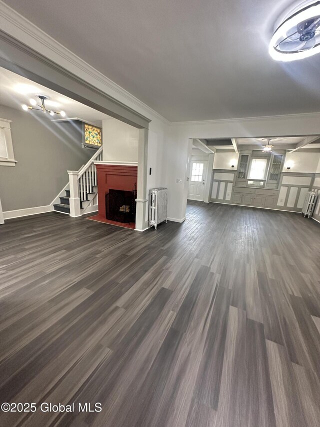 6 Alvey St, Schenectady, NY 12304 - unfurnished living room featuring radiator, dark wood-type flooring, a fireplace, stairs, and ornamental molding