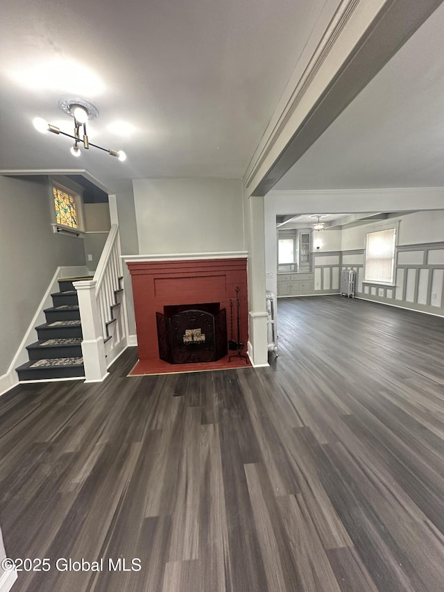 6 Alvey St, Schenectady, NY 12304 - unfurnished living room featuring dark wood-style floors, stairs, a fireplace, baseboards, and radiator heating unit