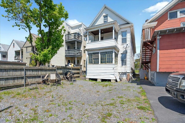rear view of property with fence