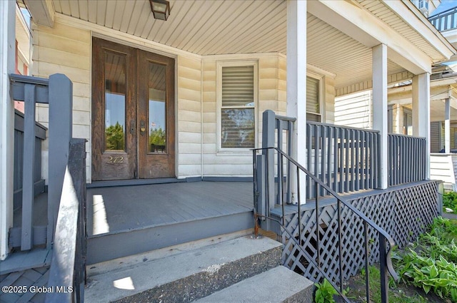 entrance to property with covered porch and french doors