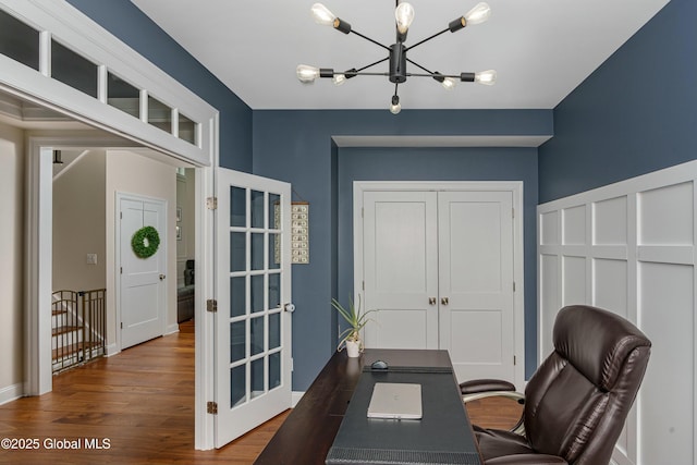 office area featuring a chandelier, wood finished floors, french doors, and baseboards