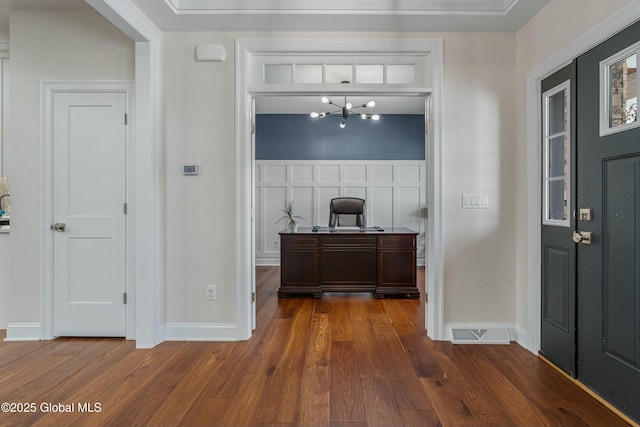 bar featuring wood finished floors and baseboards