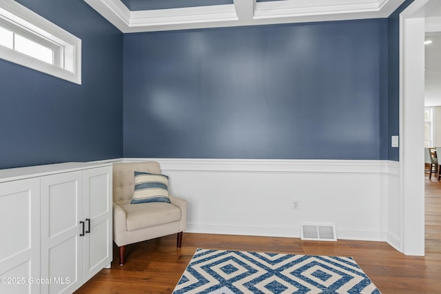 unfurnished room with wood finished floors and a wainscoted wall