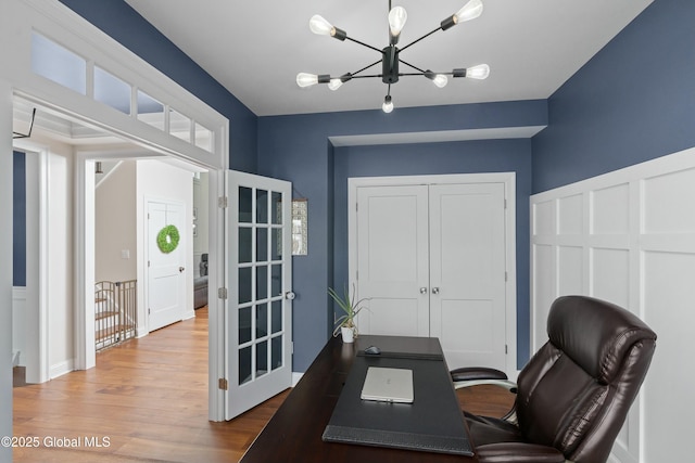 office area featuring a chandelier and wood finished floors