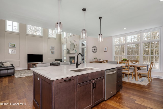 kitchen with a sink, open floor plan, stainless steel dishwasher, plenty of natural light, and recessed lighting