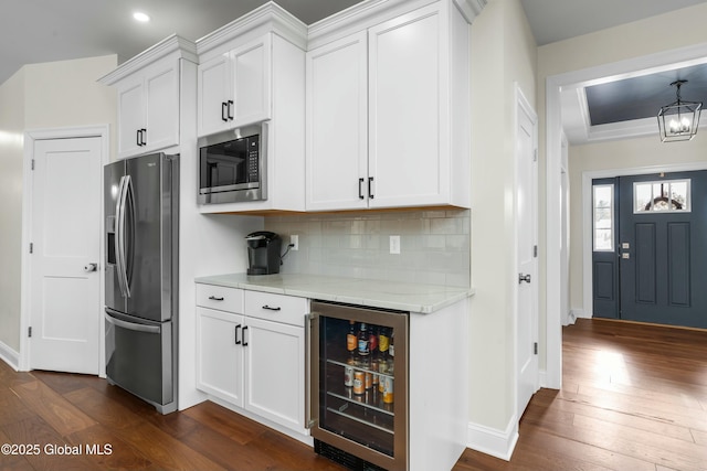 kitchen featuring stainless steel appliances, wine cooler, dark wood-style flooring, white cabinetry, and recessed lighting