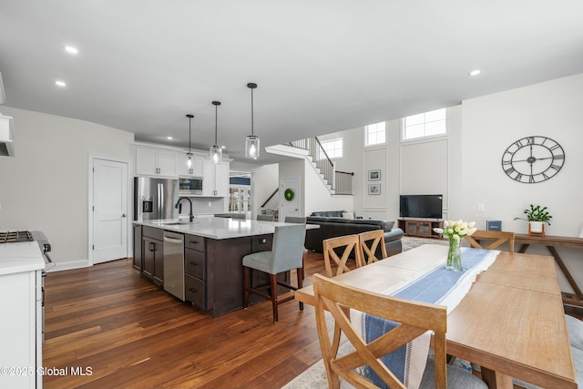 dining room featuring dark wood-style floors, stairway, recessed lighting, and baseboards