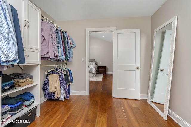 walk in closet with wood finished floors