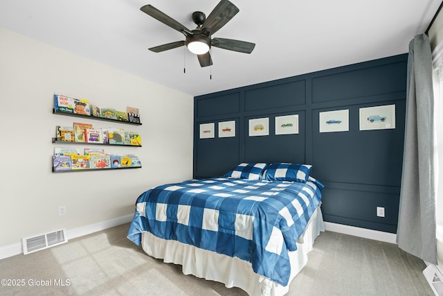 carpeted bedroom featuring baseboards and a ceiling fan