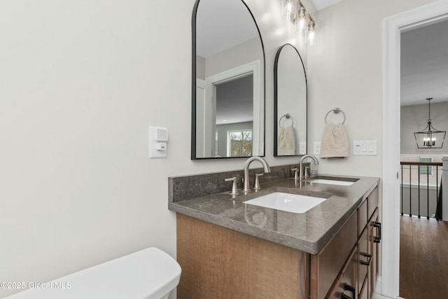 bathroom with double vanity and wood finished floors