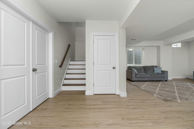 stairs featuring baseboards and wood finished floors