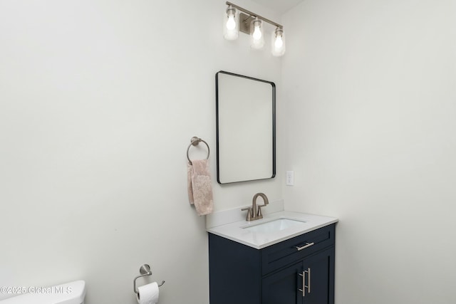 bathroom with toilet and vanity
