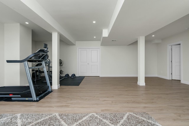 exercise room with wood finished floors, baseboards, and recessed lighting