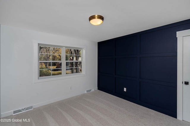 carpeted empty room with baseboards