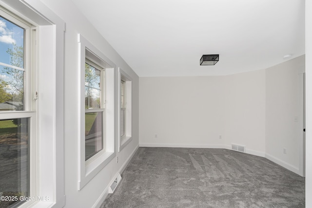 carpeted empty room with baseboards