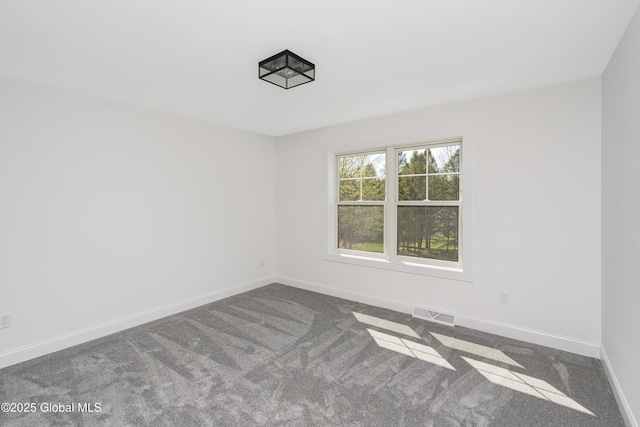 carpeted spare room with baseboards