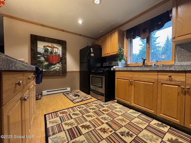 11 Beaureguard Way, Minerva, NY 12851 - kitchen featuring stainless steel gas range, a baseboard heating unit, a sink, light wood-style flooring, and recessed lighting