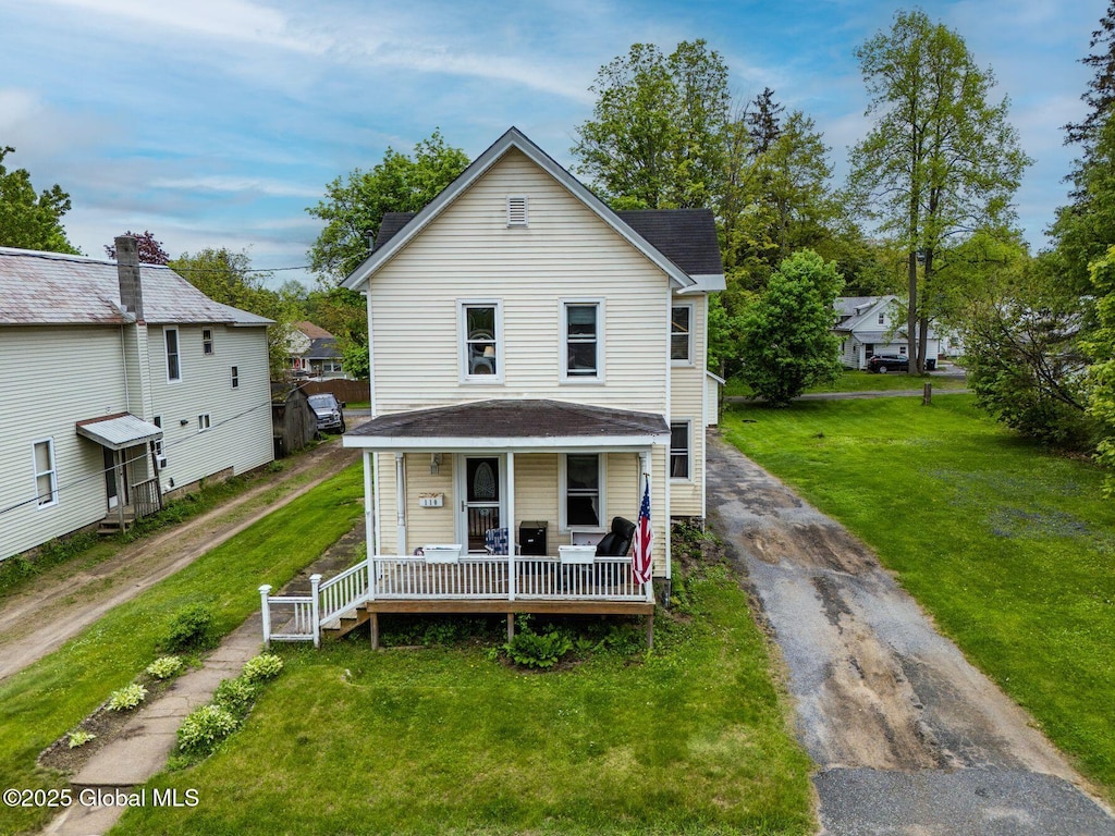 110 Oak St, Corinth, NY 12822 - view of front facade featuring driveway, covered porch, and a front lawn