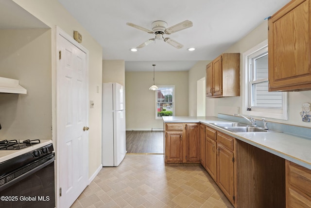 101 N Toll St, Scotia, NY 12302 - kitchen with freestanding refrigerator, gas stove, a sink, light countertops, and ceiling fan