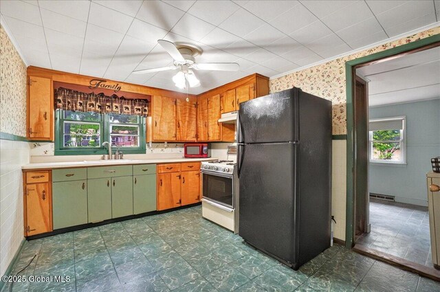 204 Greenfield Ave, Milton, NY 12020 - kitchen featuring freestanding refrigerator, wallpapered walls, white gas stove, under cabinet range hood, and a sink