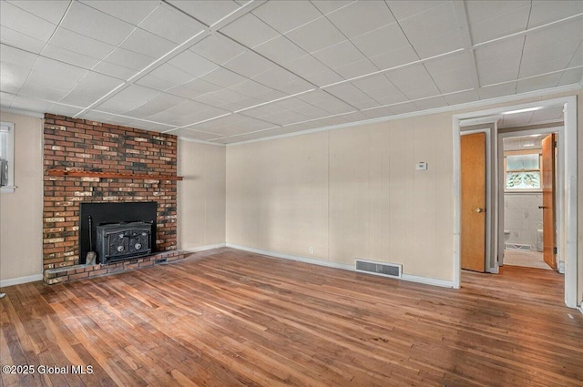 204 Greenfield Ave, Milton, NY 12020 - unfurnished living room with hardwood / wood-style flooring, a wood stove, baseboards, and ornamental molding