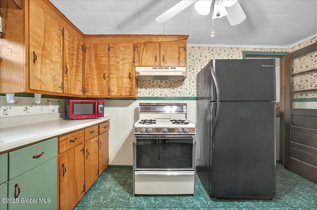 204 Greenfield Ave, Milton, NY 12020 - kitchen with freestanding refrigerator, gas stove, under cabinet range hood, wallpapered walls, and light countertops