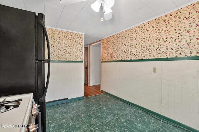 204 Greenfield Ave, Milton, NY 12020 - kitchen with wallpapered walls, freestanding refrigerator, wainscoting, dark floors, and range with gas cooktop