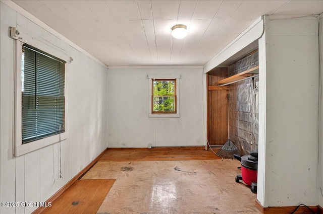 204 Greenfield Ave, Milton, NY 12020 - unfurnished bedroom featuring crown molding, a closet, and wood walls