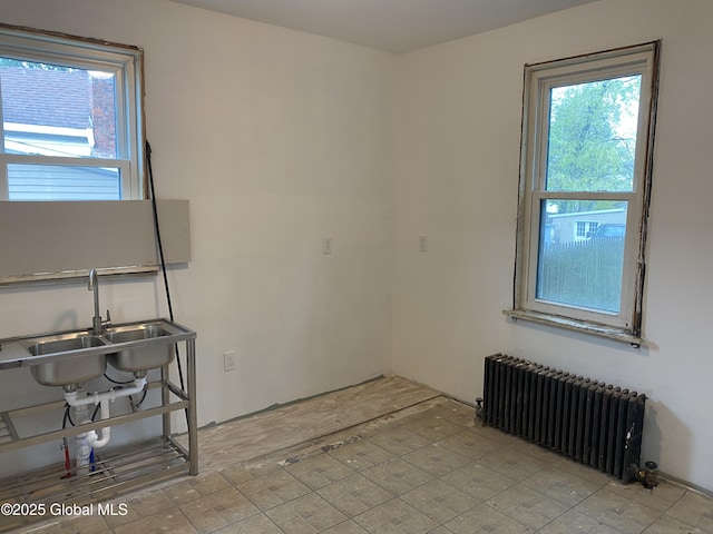 20 Henry St, Schenectady, NY 12304 - spare room featuring radiator, healthy amount of natural light, and a sink