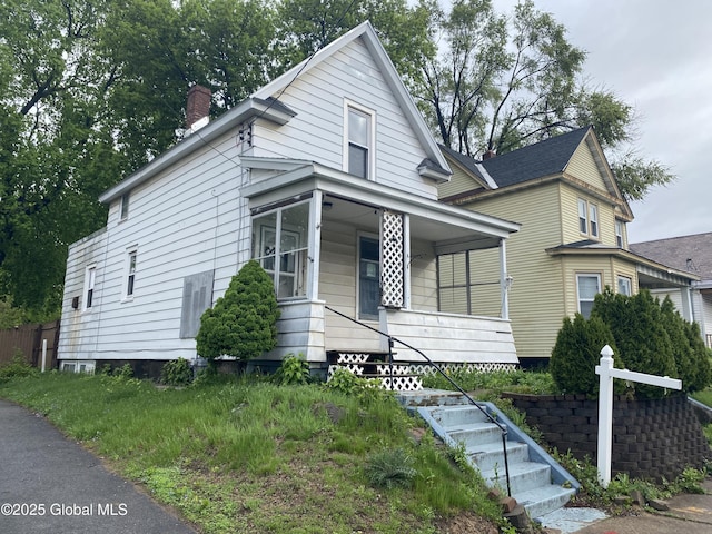 20 Henry St, Schenectady, NY 12304 - view of front facade with a chimney, a porch, and stairs