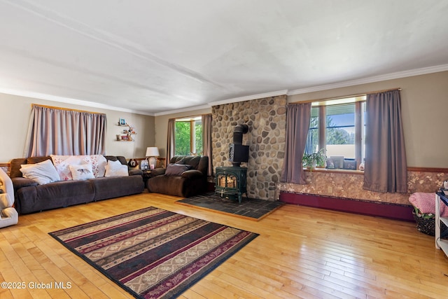 18 Main St, Berne, NY 12059 - living area featuring a wood stove, plenty of natural light, hardwood / wood-style floors, and crown molding