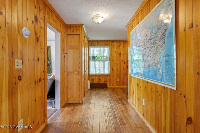18 Main St, Berne, NY 12059 - corridor featuring light wood-style flooring, wood walls, and baseboards