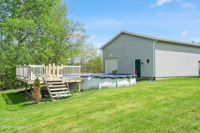18 Main St, Berne, NY 12059 - view of green lawn with a deck, a covered pool, and a garage