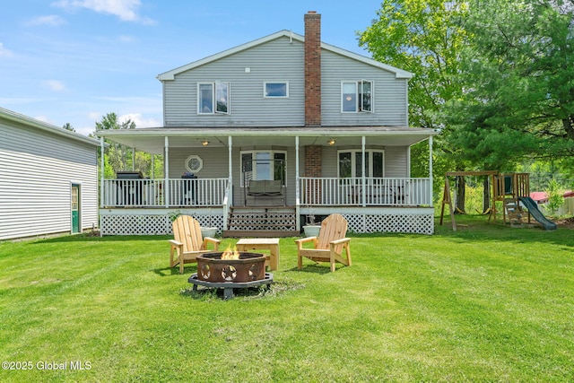 18 Main St, Berne, NY 12059 - rear view of property with a fire pit, a lawn, a chimney, and a playground