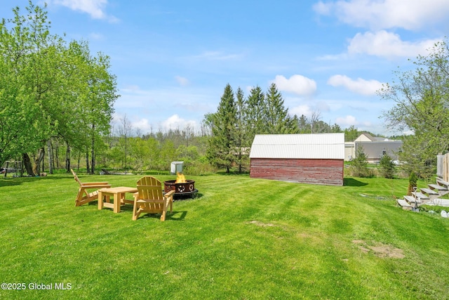 18 Main St, Berne, NY 12059 - view of grassy yard with a fire pit and an outdoor structure