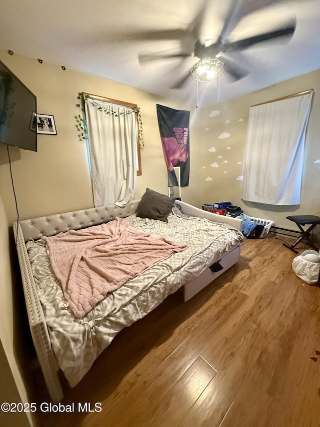 bedroom with wood finished floors and ceiling fan