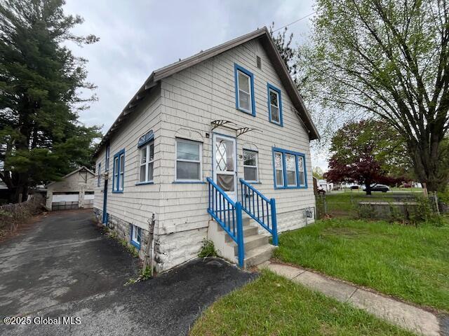 3 Tulip St, Rotterdam, NY 12306 - view of front of property with a garage, a front lawn, and an outbuilding