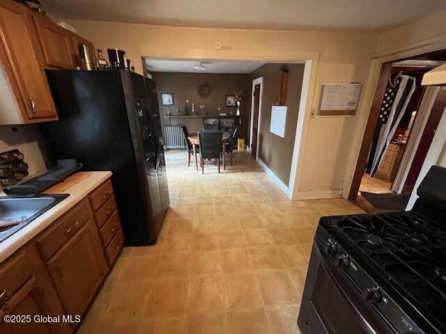 3 Tulip St, Rotterdam, NY 12306 - kitchen with black appliances, brown cabinets, light countertops, and a sink