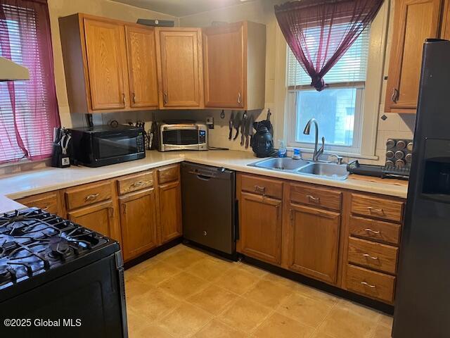 3 Tulip St, Rotterdam, NY 12306 - kitchen with black appliances, a sink, light countertops, and brown cabinets