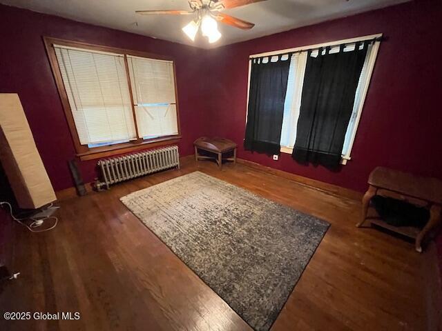 3 Tulip St, Rotterdam, NY 12306 - bedroom featuring radiator heating unit, wood finished floors, a ceiling fan, and baseboards