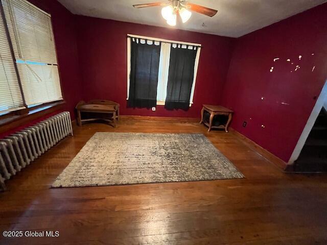 3 Tulip St, Rotterdam, NY 12306 - bedroom with radiator, wood finished floors, baseboards, and ceiling fan