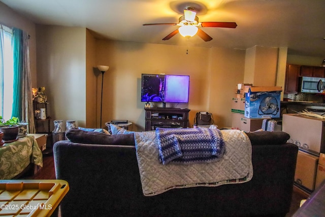 living area featuring a ceiling fan and wood finished floors