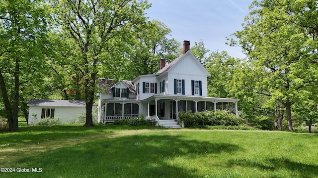 601/603 Baldwin Rd, Ticonderoga, NY 12883 - view of front facade featuring a sunroom, a chimney, and a front lawn